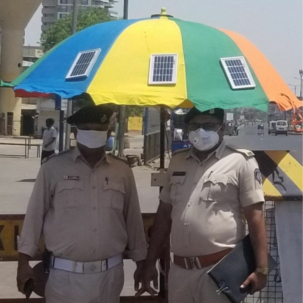 Ahmedabad Cops enjoying under Umbrella